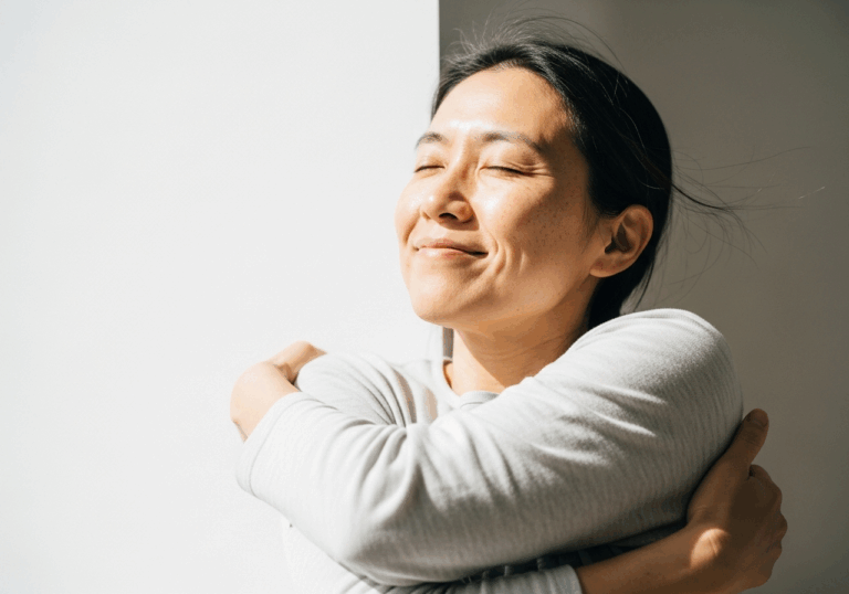 A brief self-hug (crossing arms gently) for 20 seconds during stress lowers cortisol by ~14% and speeds recovery, lifting mood via tactile self-compassion signals.